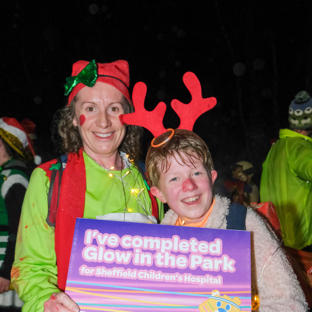 A woman and a boy at Glow in the Park, they are in festive fancy dress